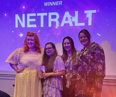 photo of NETRALT collecting award from Michelle McManus